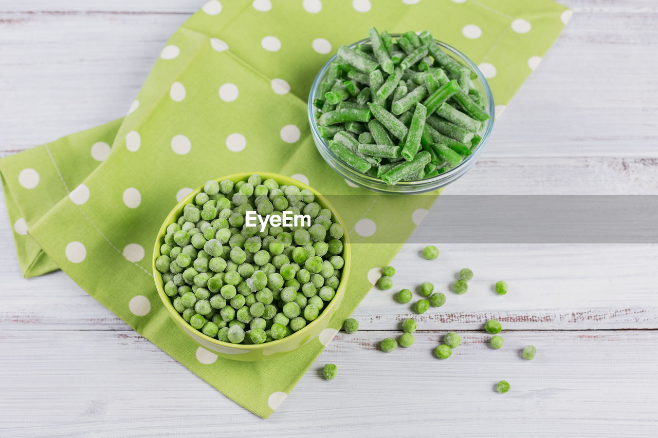 Composition with different organic frozen vegetables on a white background