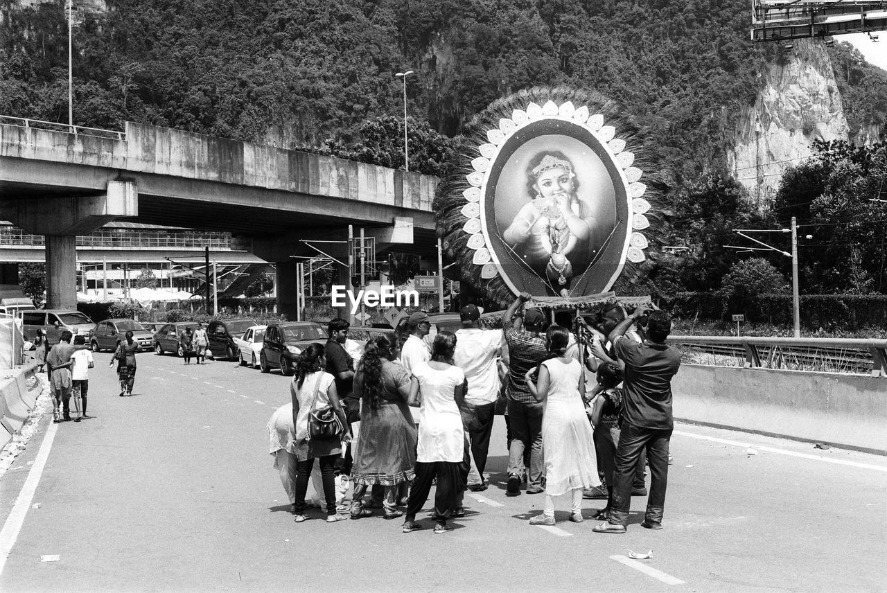 PEOPLE STANDING ON MOTORCYCLE