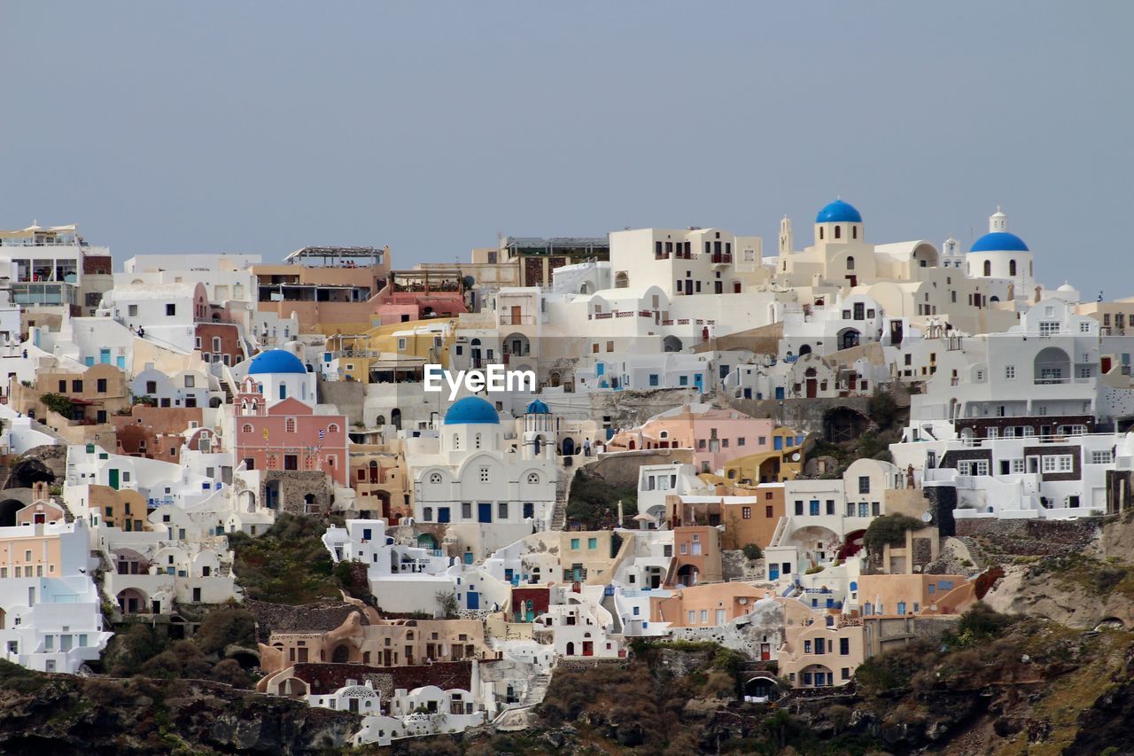 Buildings in city against clear sky