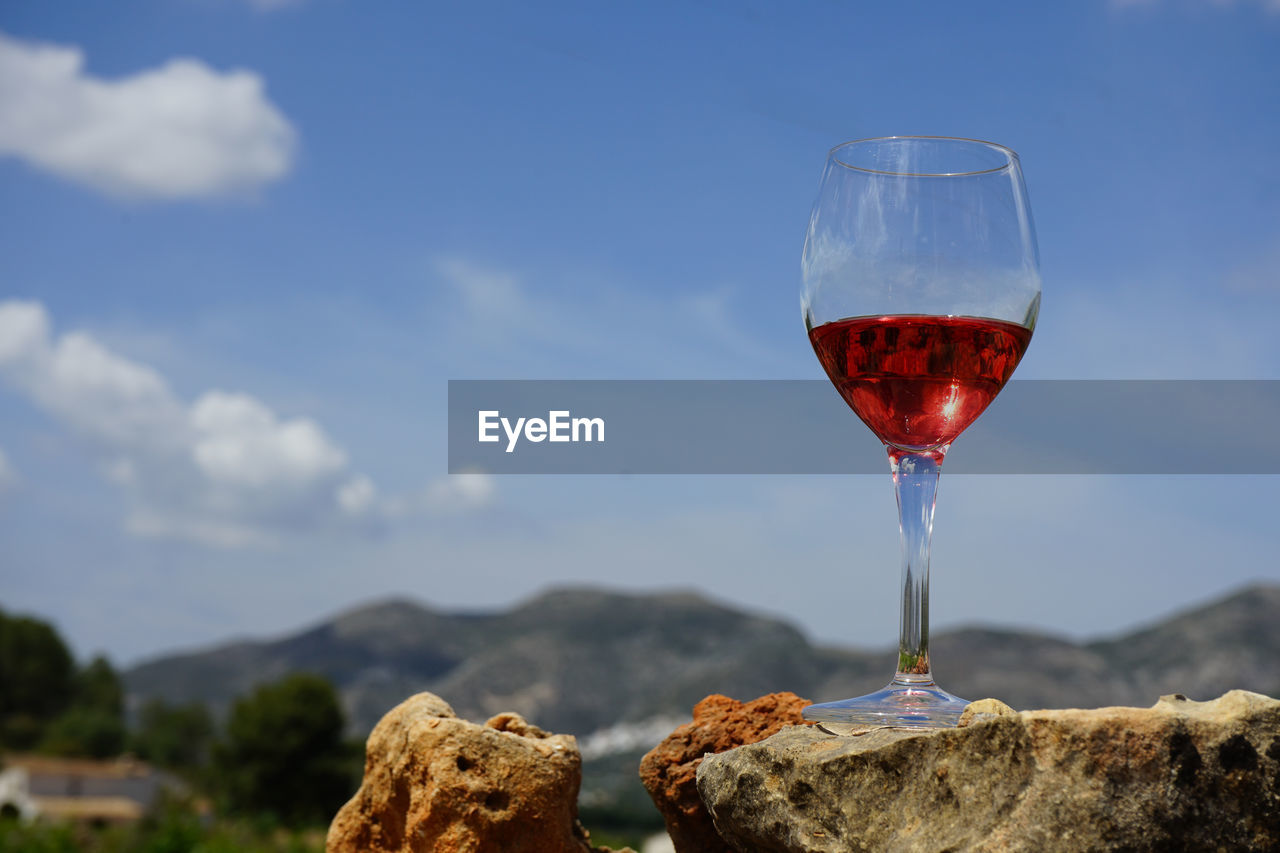 CLOSE-UP OF RED WINE AGAINST SKY