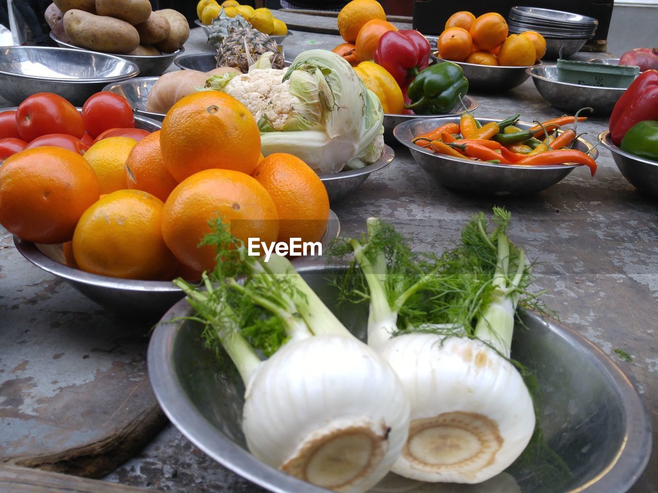 Close-up of vegetables and fruits in bowls for sale