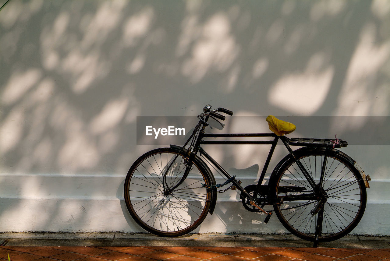 Bicycle parked against wall