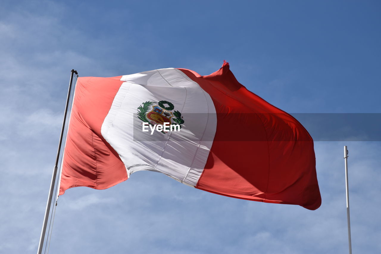 Low angle view of peruvian flag against sky