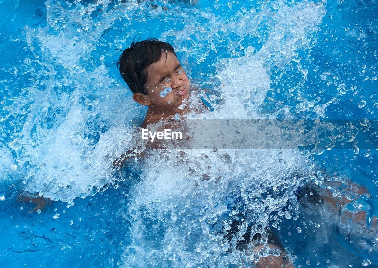 FULL LENGTH OF MAN SWIMMING IN POOL