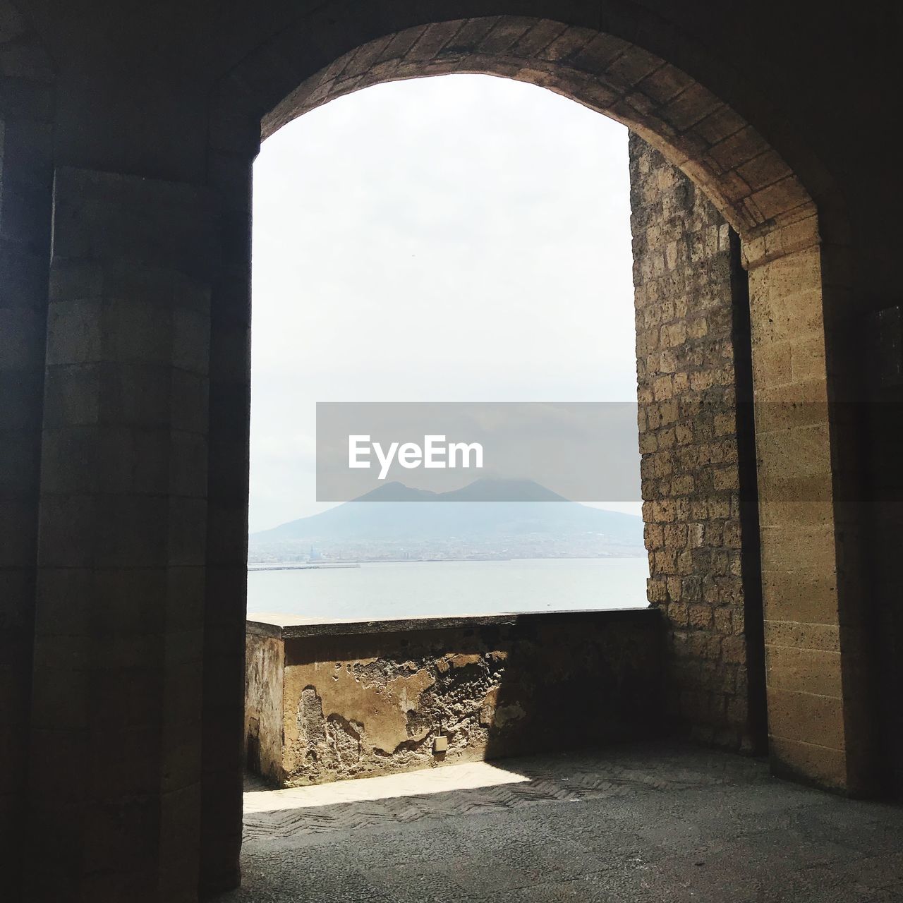 Interior of historic building by sea against sky 