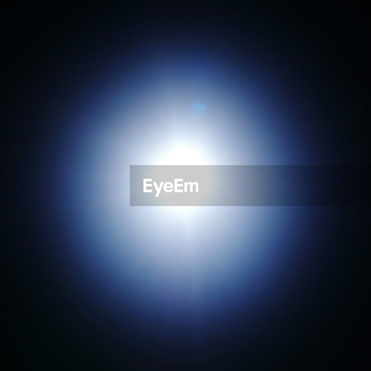 LOW ANGLE VIEW OF SUN SHINING THROUGH CLOUDS