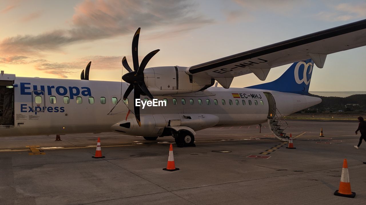 TEXT ON AIRPLANE AGAINST SKY AT SUNSET