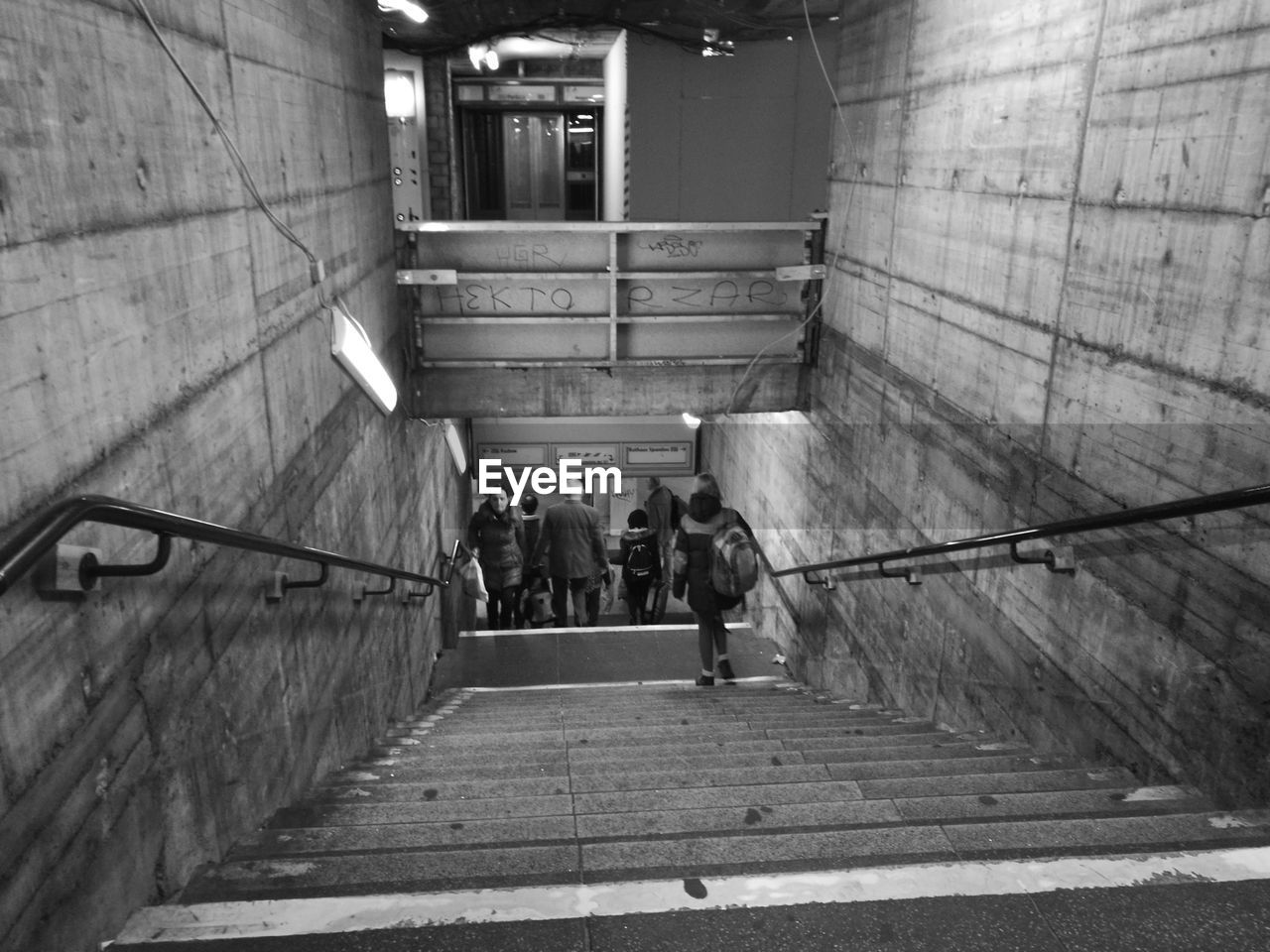 PEOPLE WALKING ON STAIRS IN SUBWAY