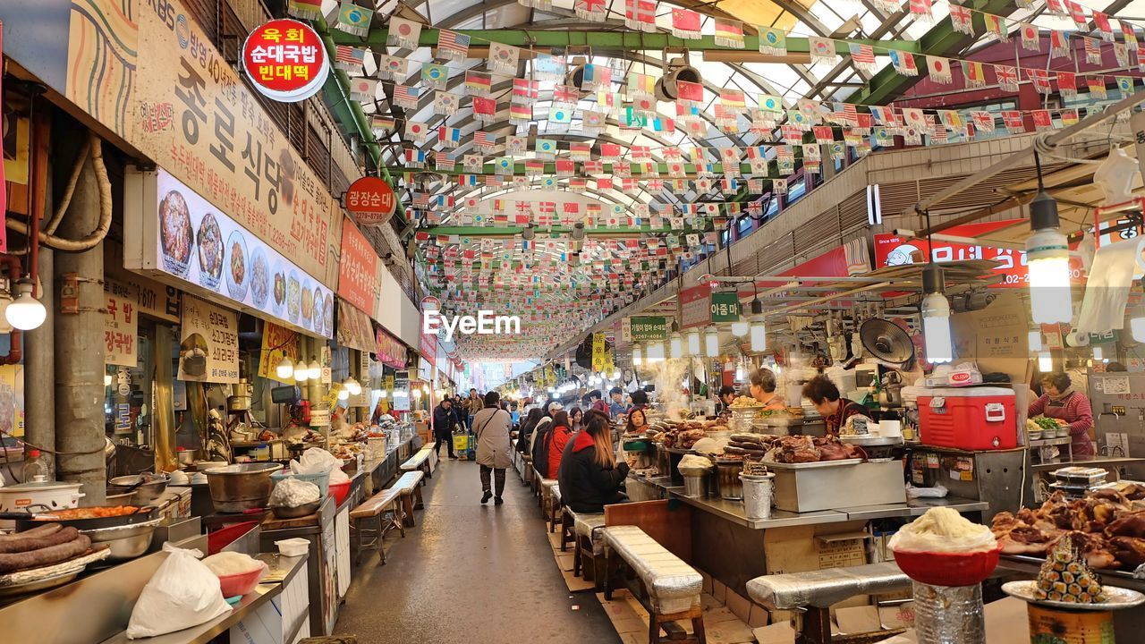 GROUP OF PEOPLE IN MARKET STALL