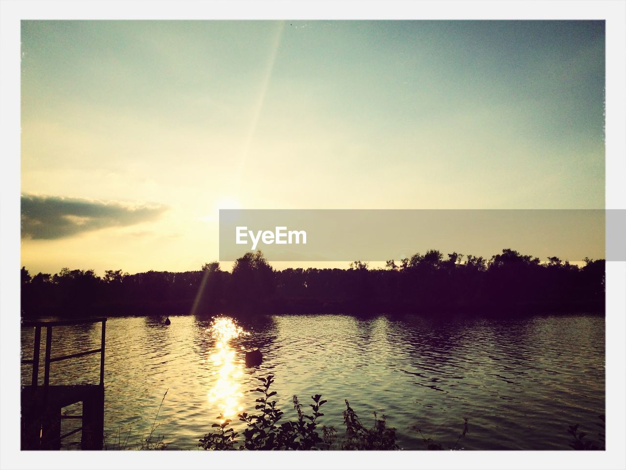 Scenic view of river against sky during sunset