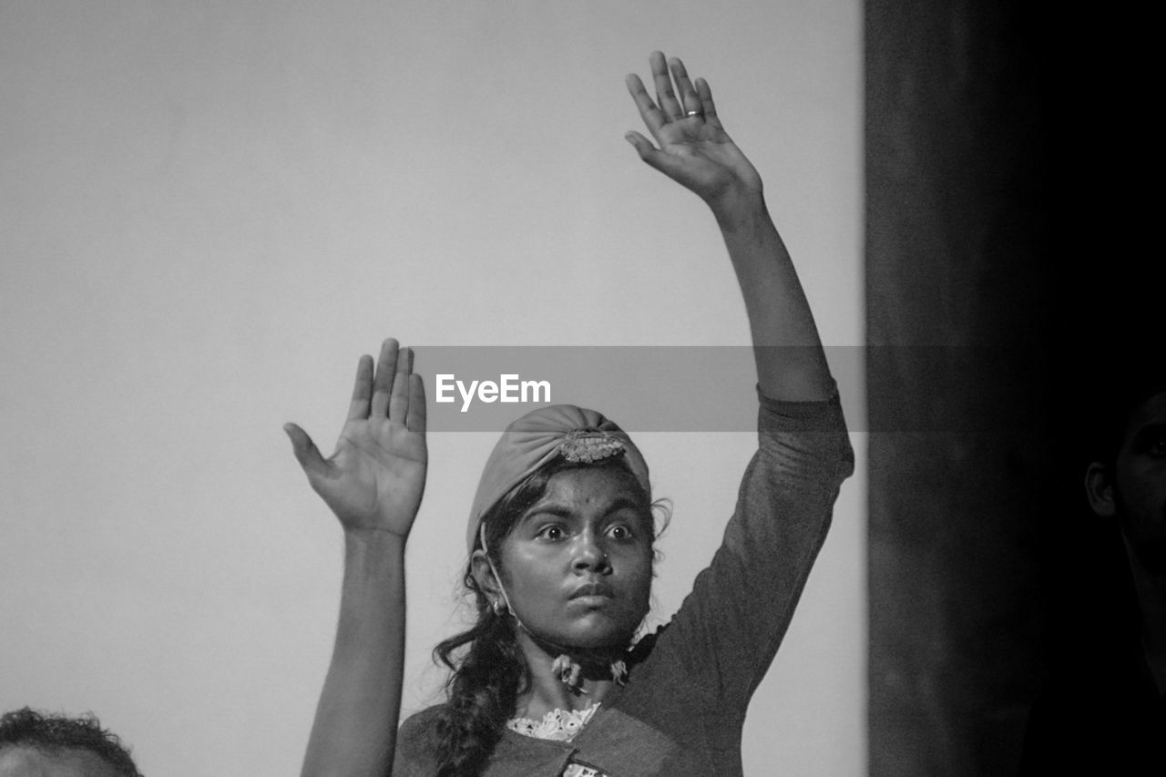 black and white, black, arm, arms raised, monochrome, monochrome photography, white, limb, human limb, adult, hand raised, portrait, women, headshot, person, performance art, group of people, men, hand, arts culture and entertainment, human face, indoors
