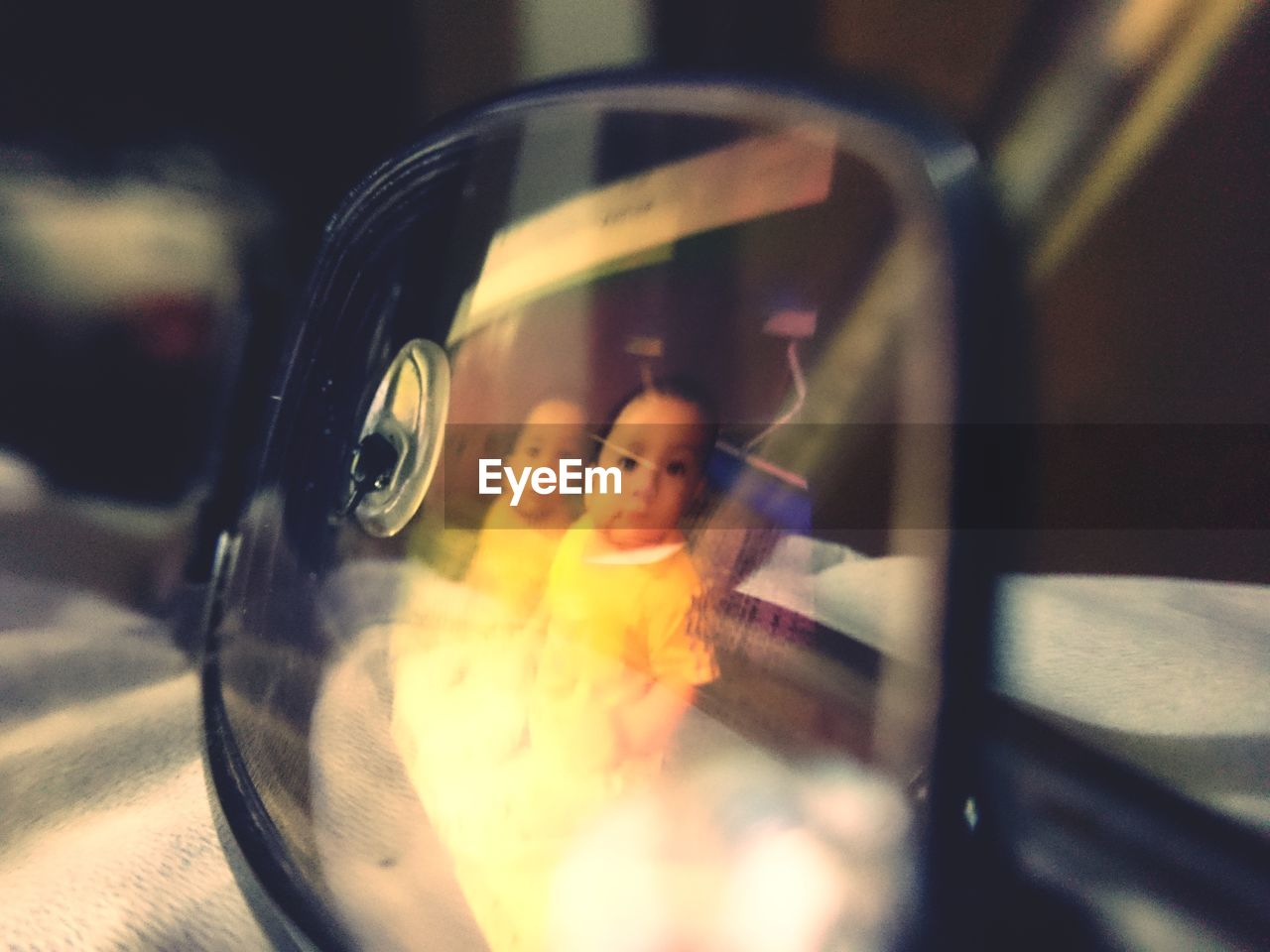 PORTRAIT OF WOMAN PHOTOGRAPHING REFLECTION ON SIDE-VIEW MIRROR OF CAR