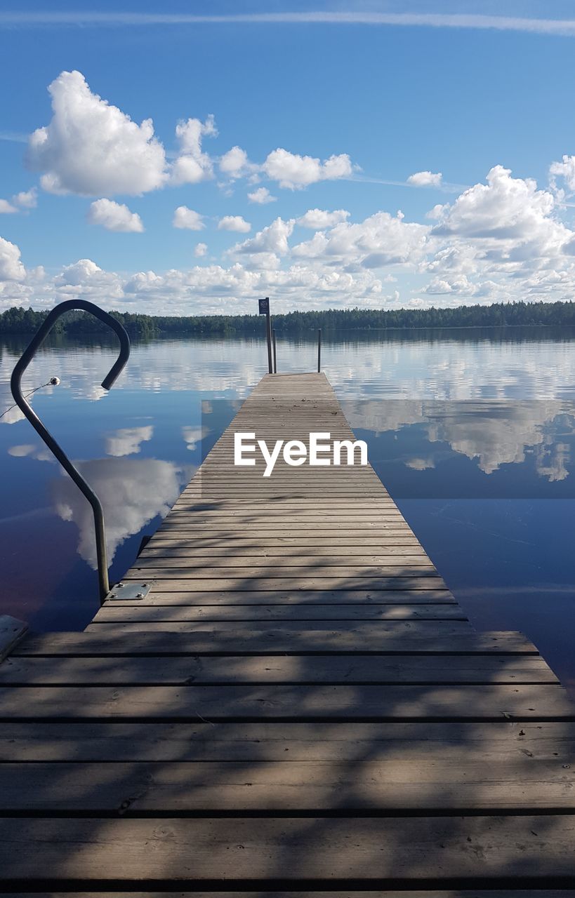 Pier over lake against sky