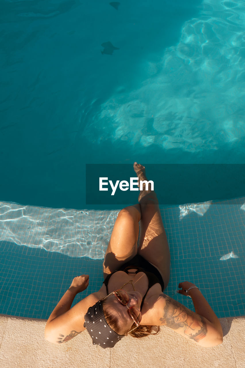 High angle view of young woman in swimming pool