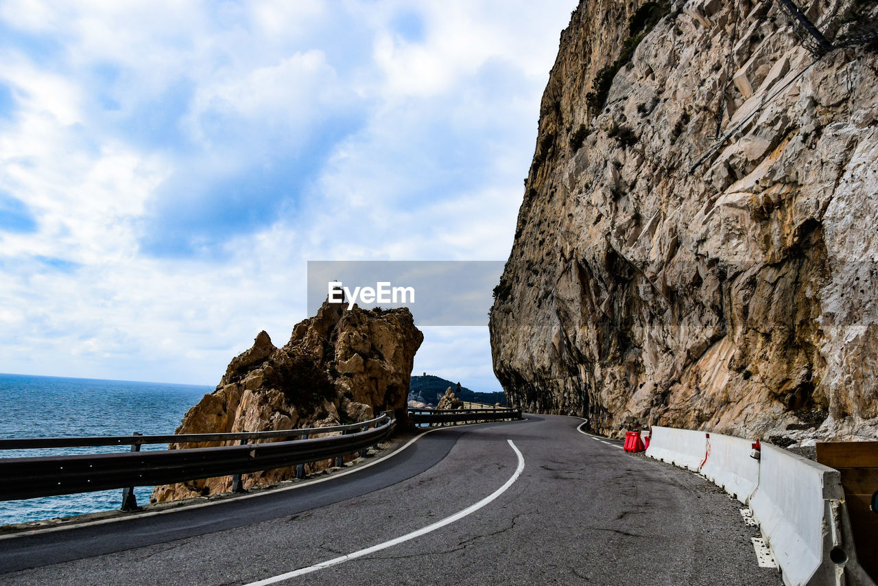 Road by sea against sky