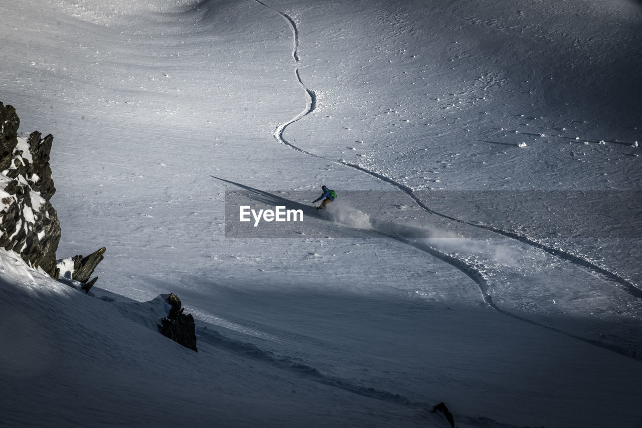 Person skiing on snowcapped mountain