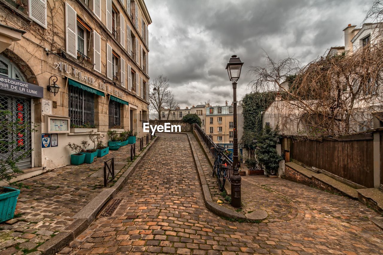 Street amidst buildings against sky