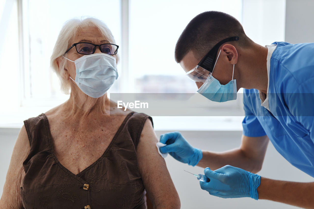 Doctor injecting vaccine to patient