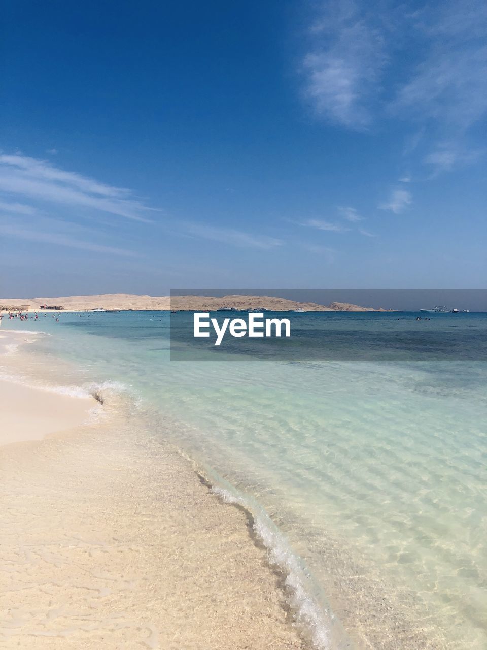 Scenic view of beach against blue sky