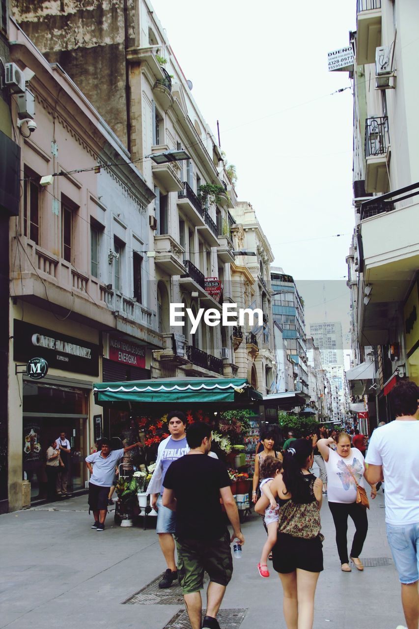 PEOPLE WALKING ON STREET IN CITY