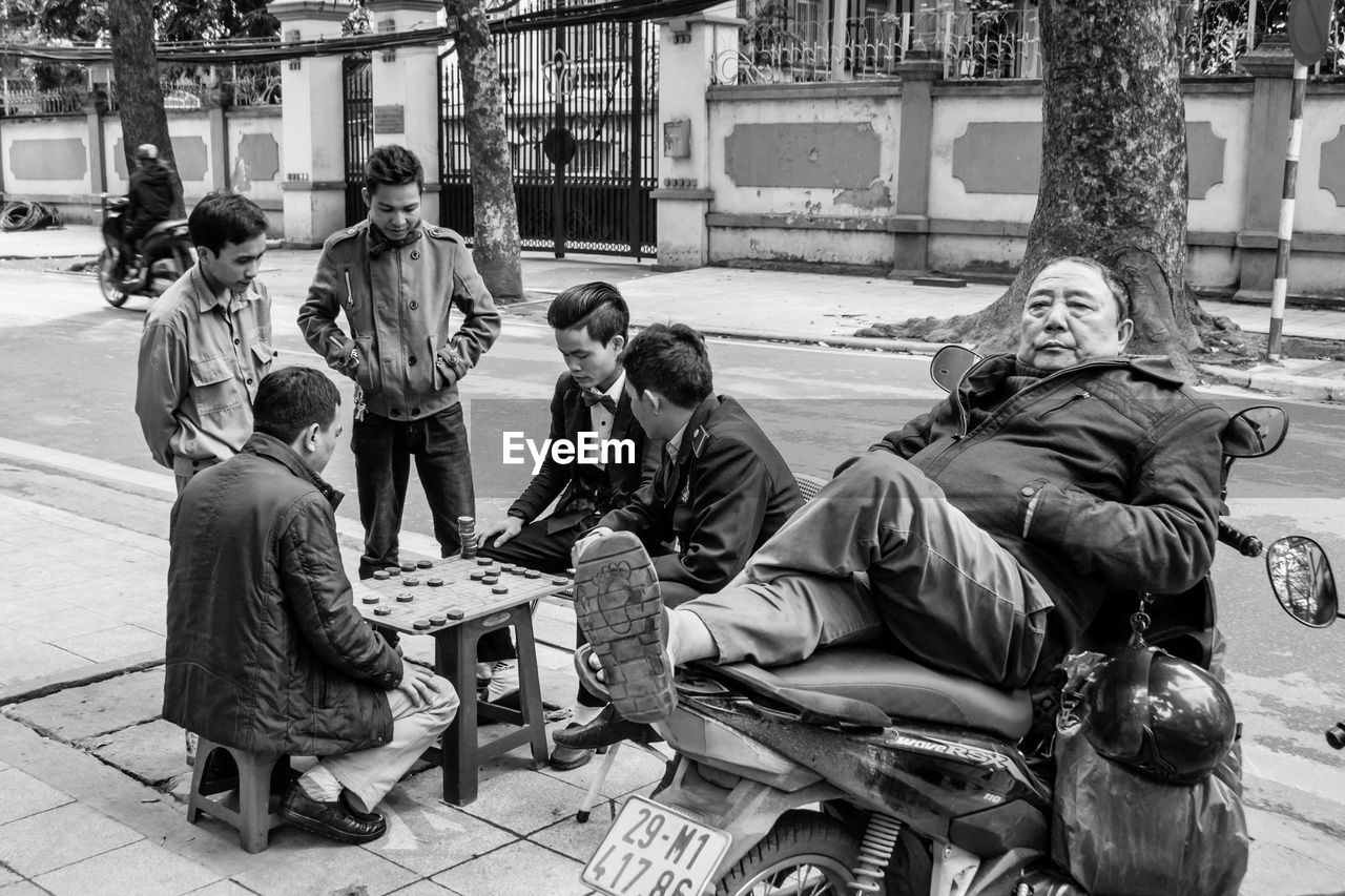 PEOPLE SITTING AT MARKET