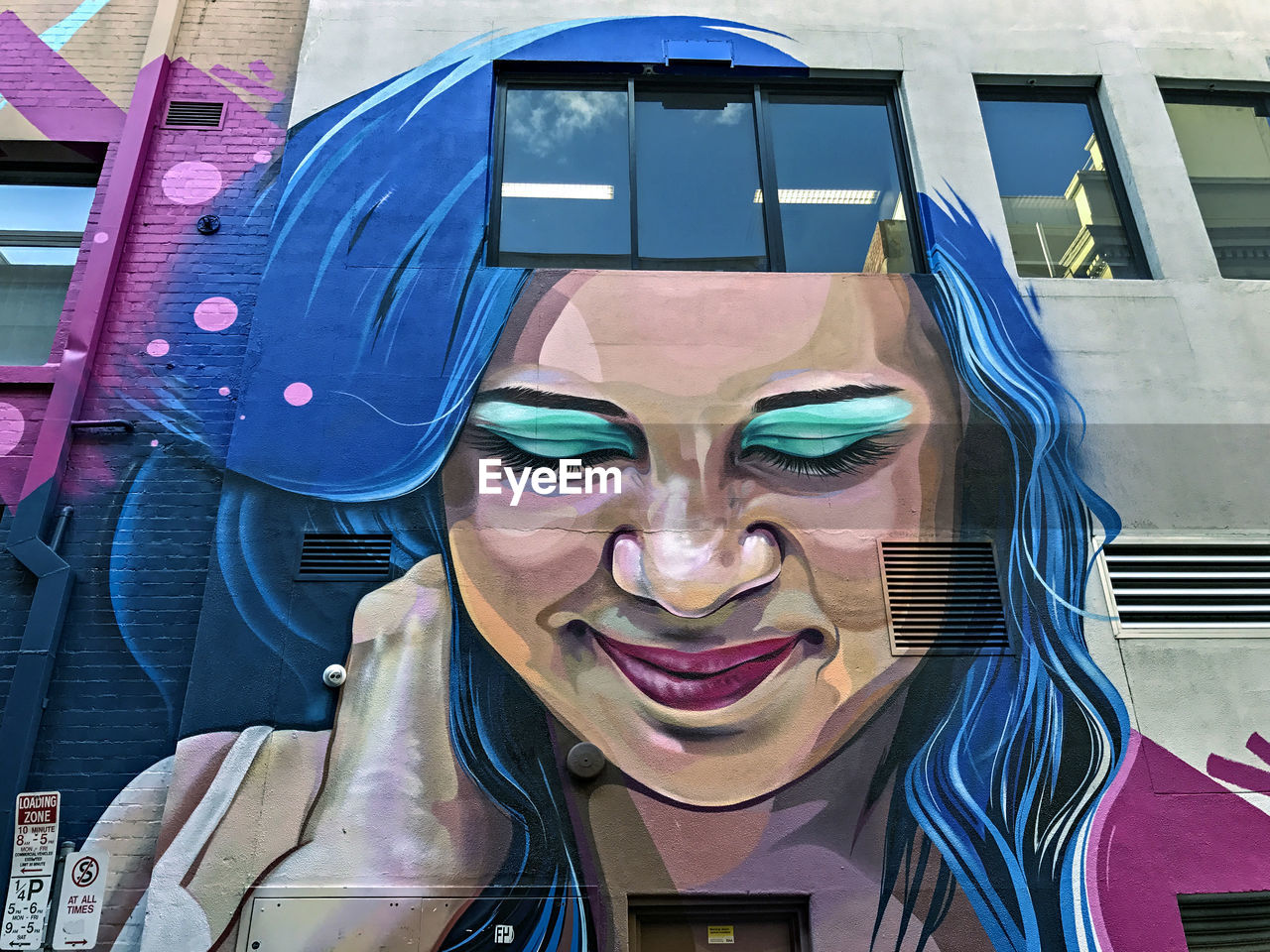 PORTRAIT OF A SMILING WOMAN WITH REFLECTION