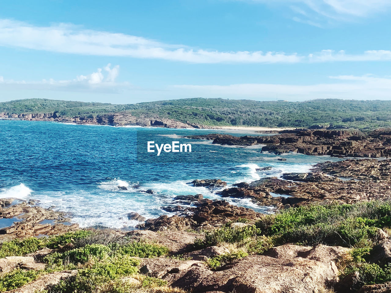 SCENIC VIEW OF SEA BY ROCKS AGAINST SKY