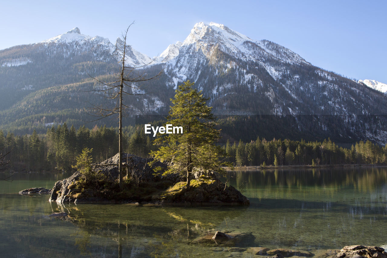 scenic view of lake and mountains against clear sky