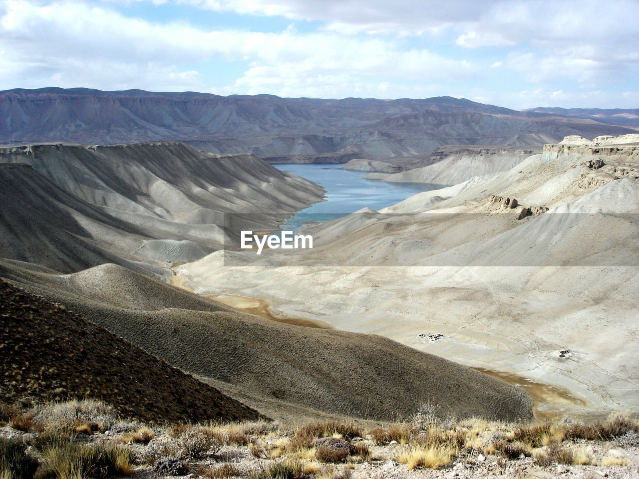 Scenic view of mountains against cloudy sky