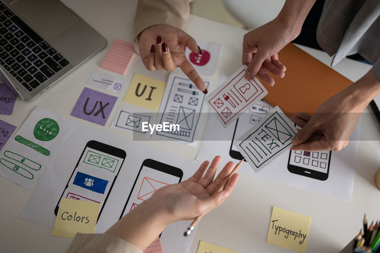 high angle view of business colleagues working on table in office