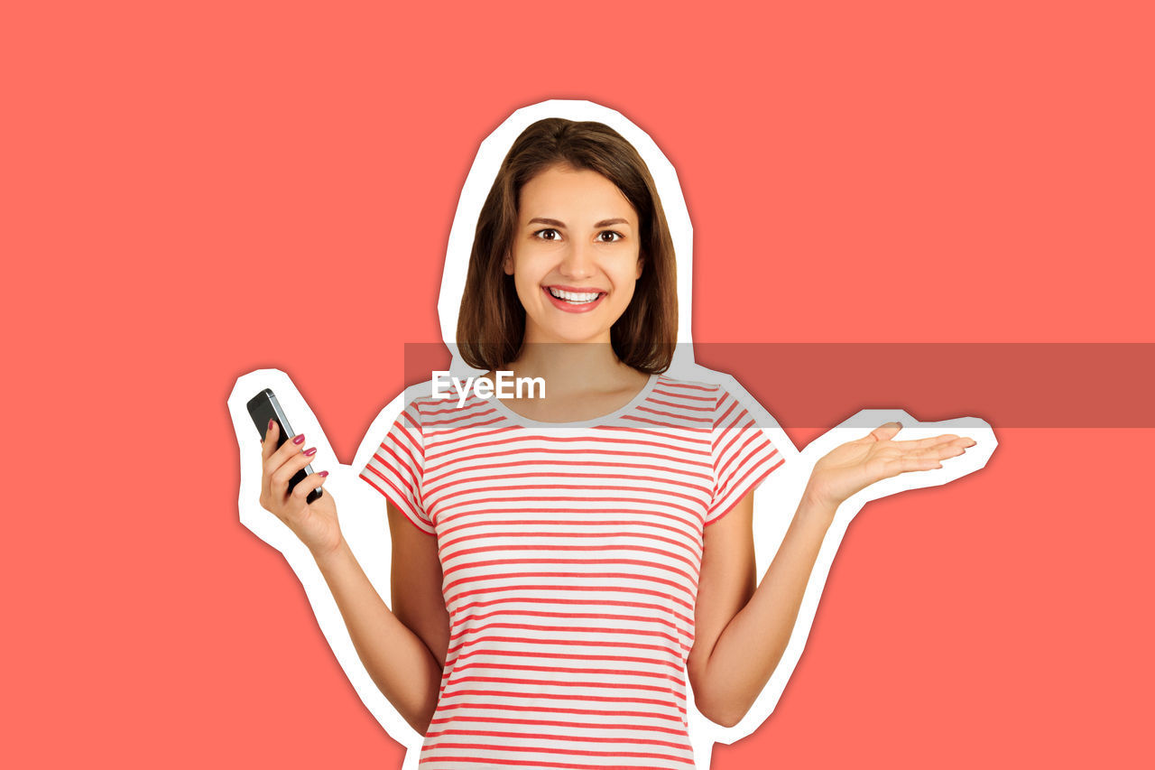 Digital composite image of smiling woman holding smart phone while gesturing against peach background