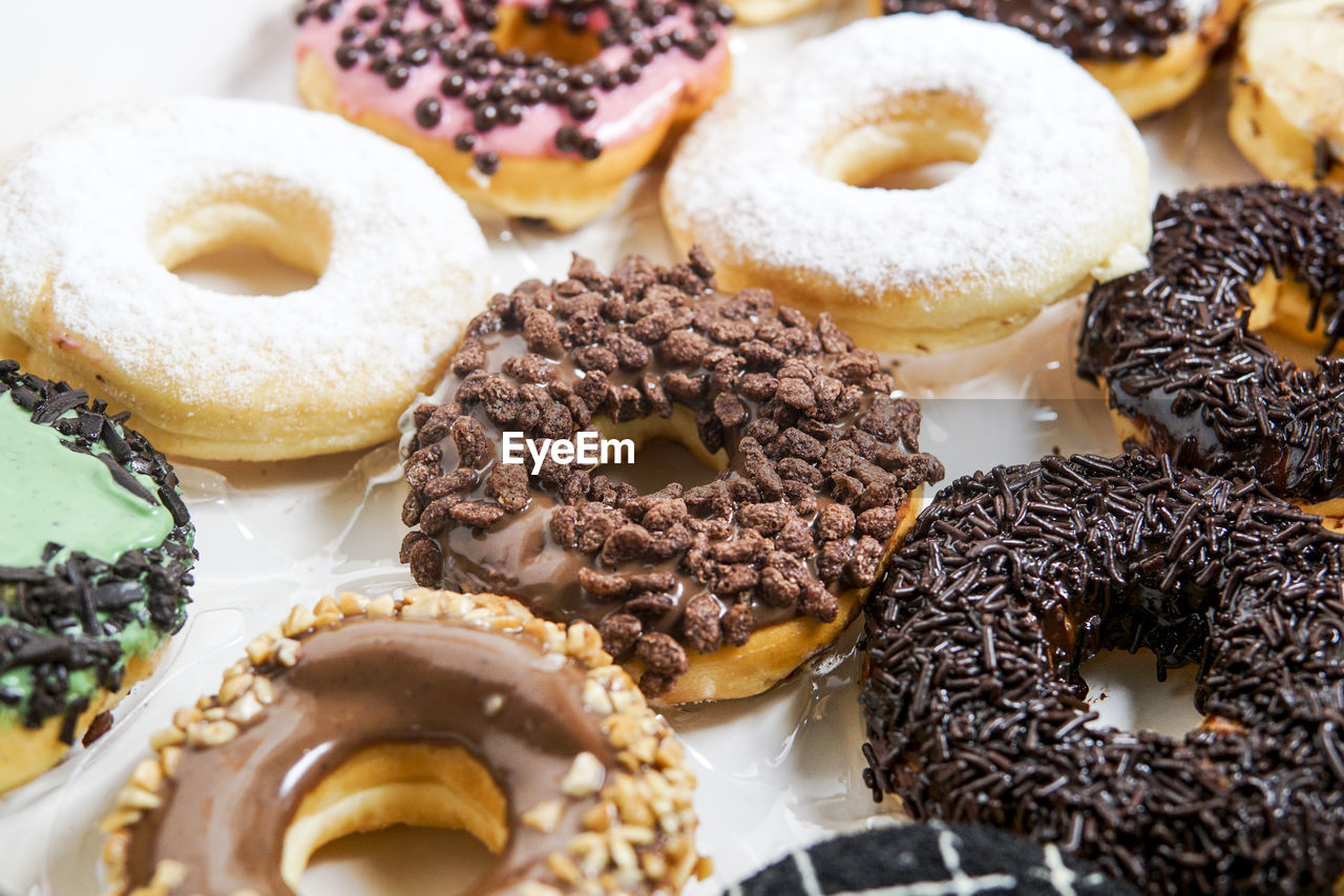 Full frame shot of various donuts arranged in tray