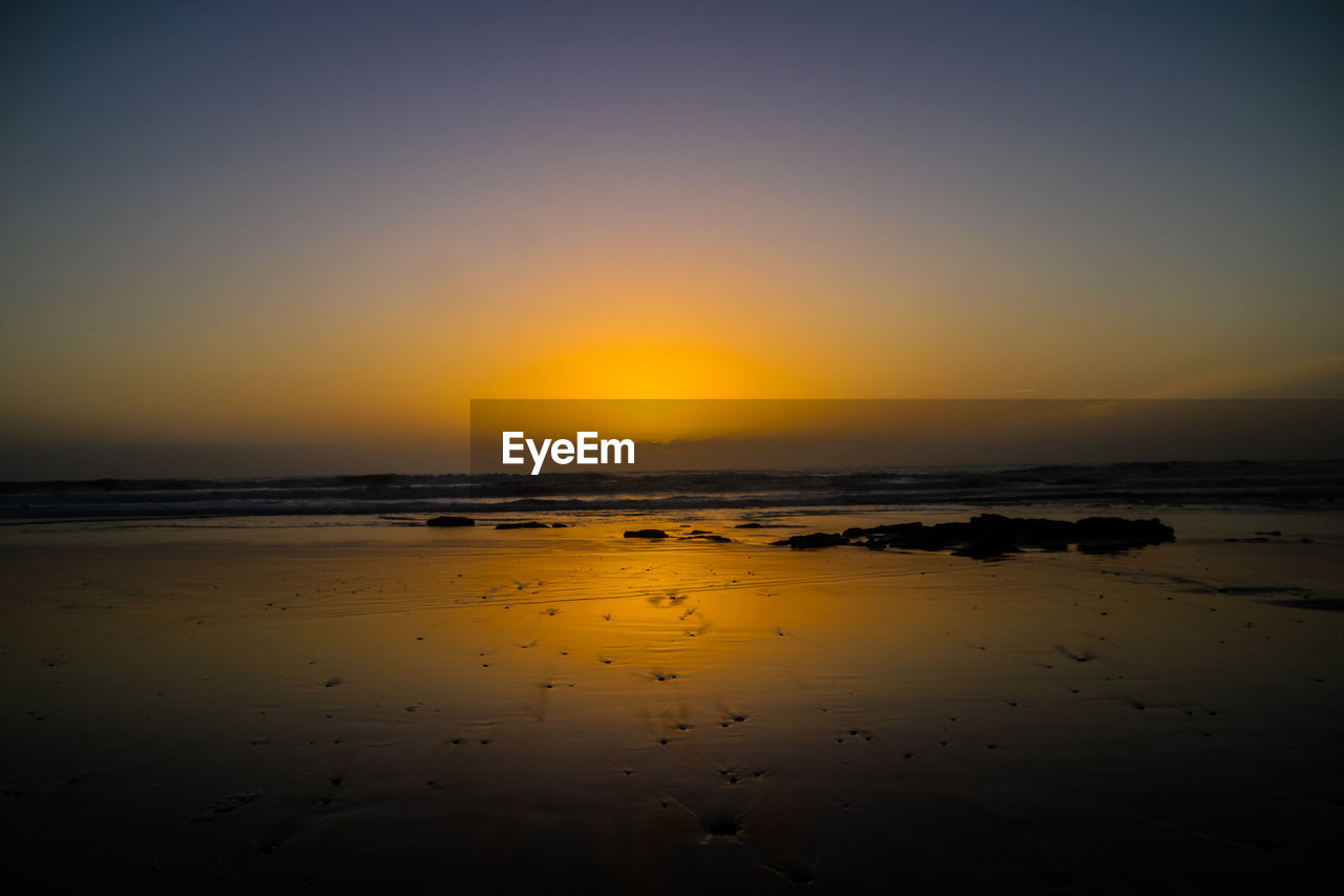 Scenic view of sea against sky during sunset