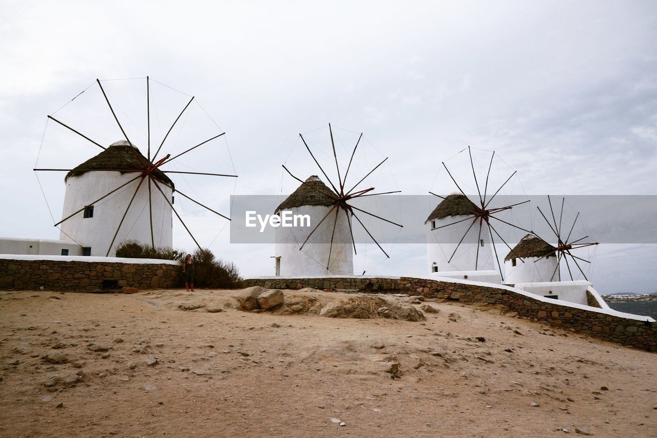 WIND TURBINES ON BEACH AGAINST SKY