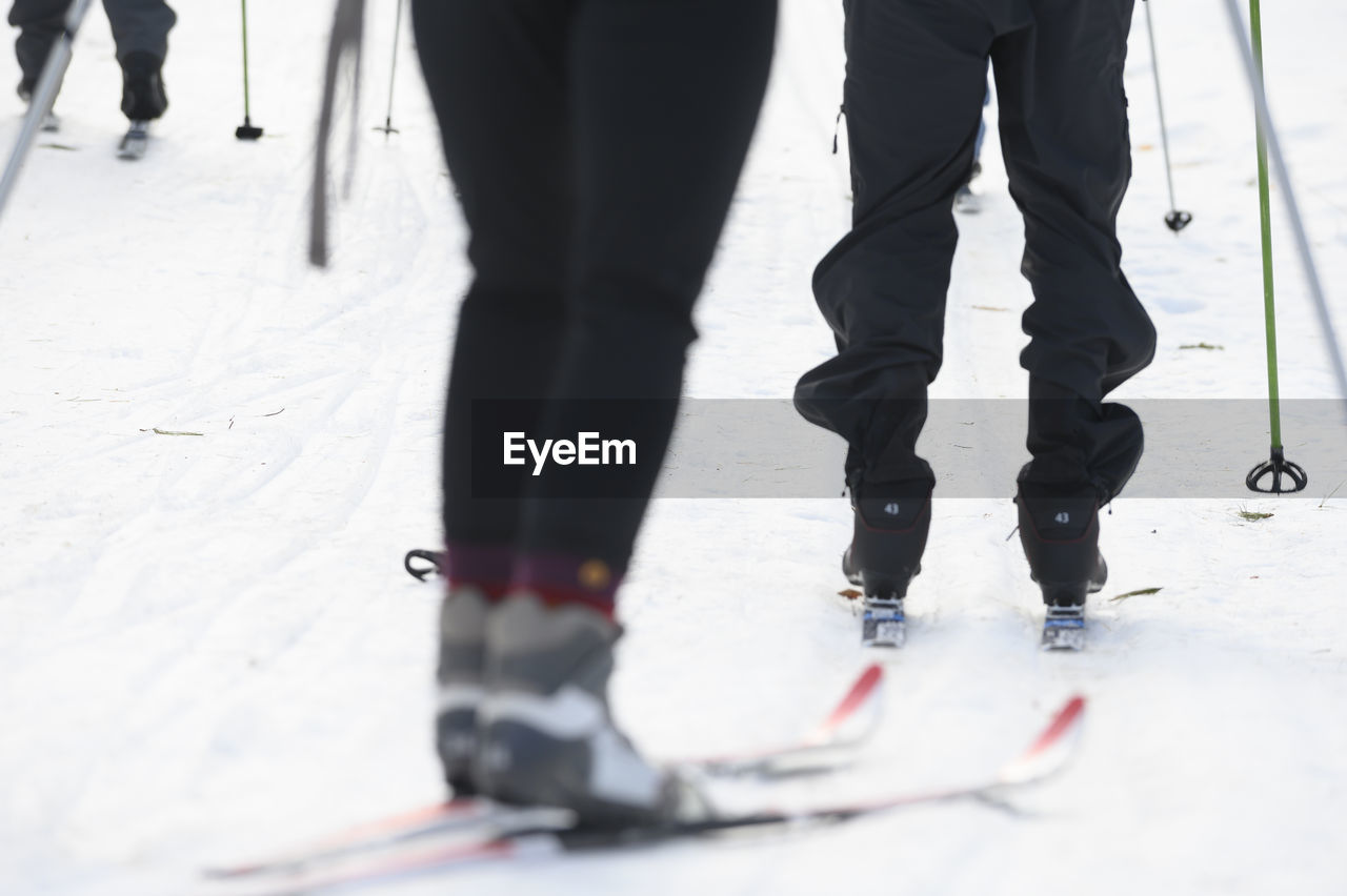 Three skiers heading out to ski at a nordic center