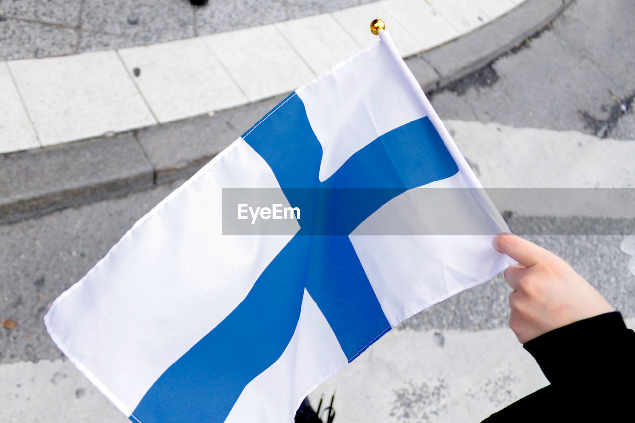 Holding a small finnish flag
