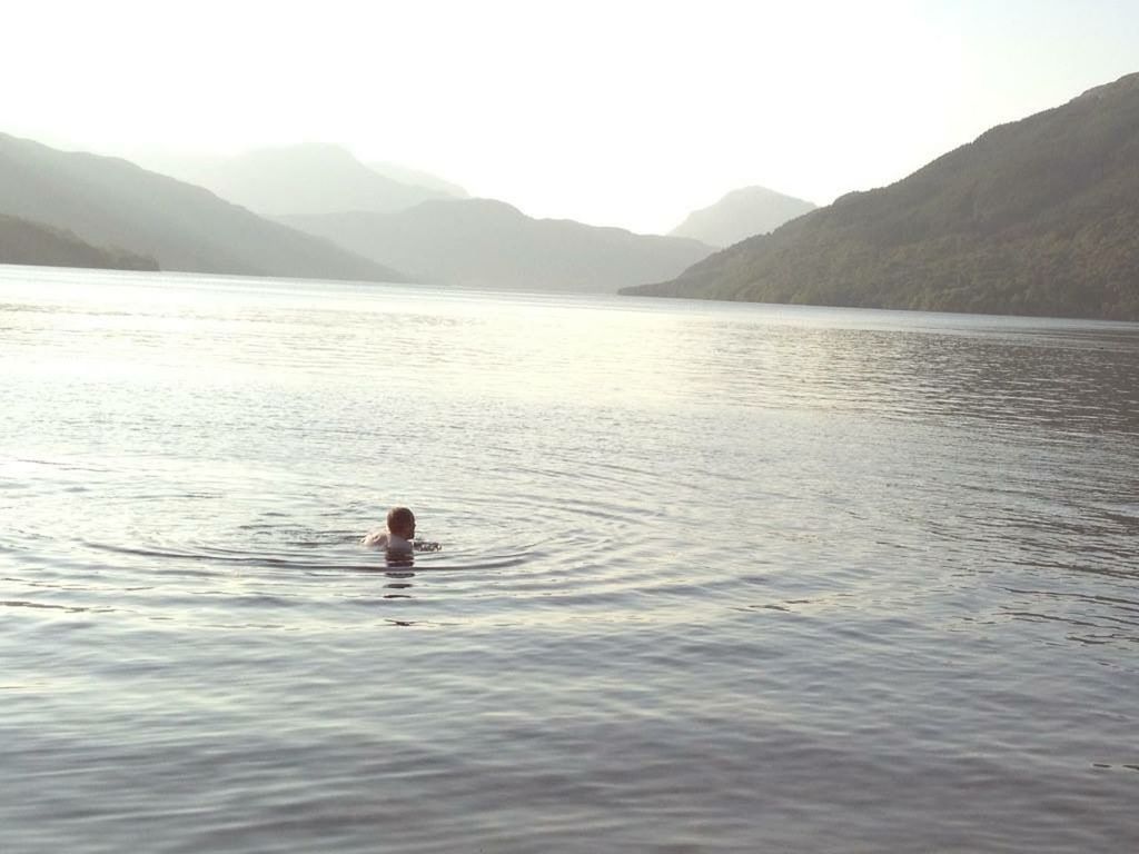 SCENIC VIEW OF LAKE WITH MOUNTAINS IN BACKGROUND