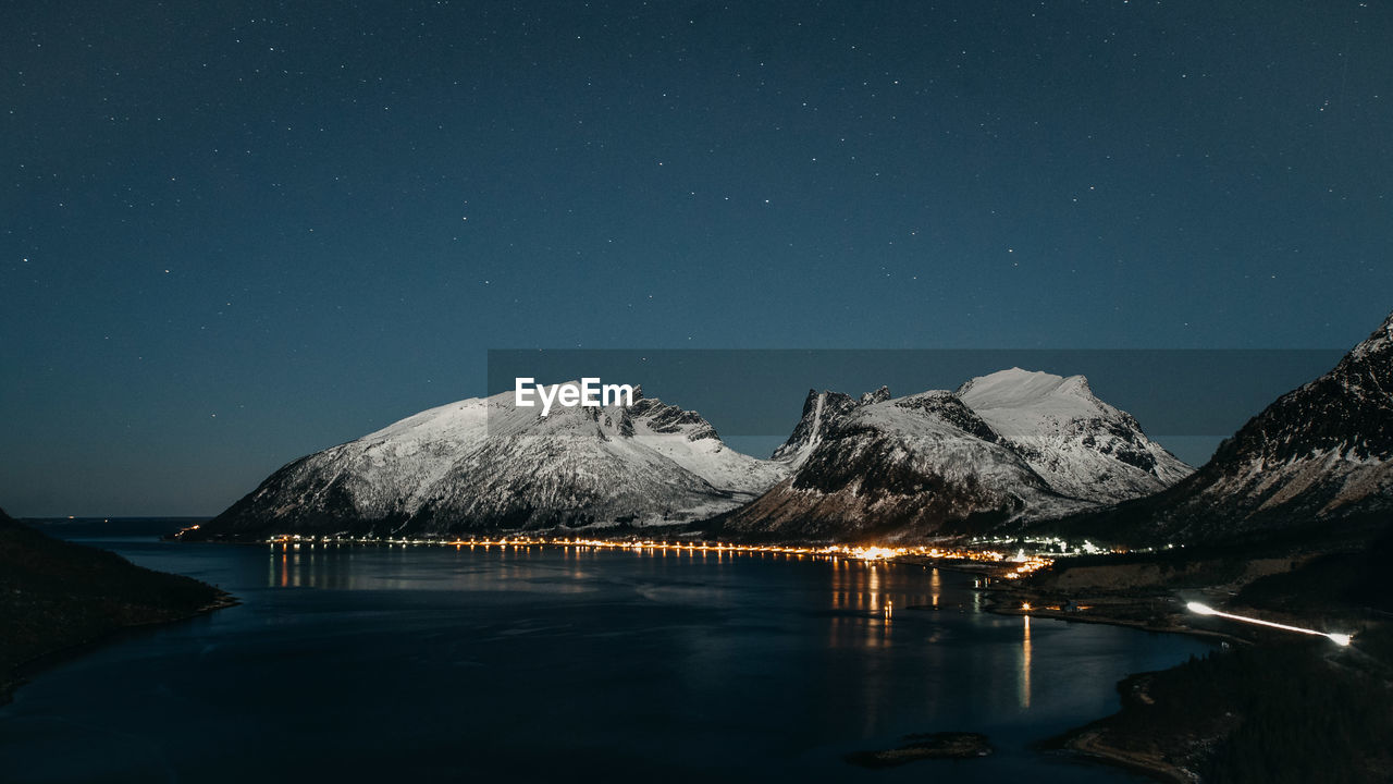 SCENIC VIEW OF SNOWCAPPED MOUNTAIN AGAINST SKY AT NIGHT