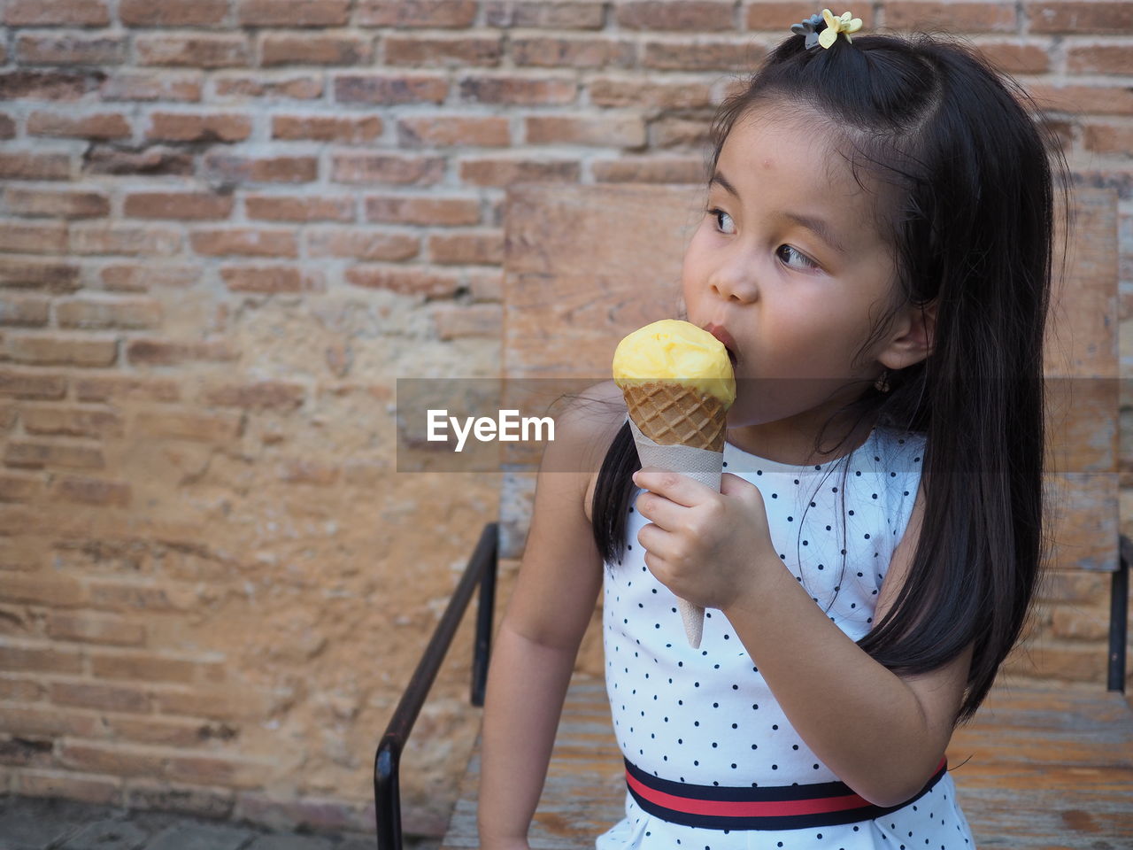 Cute girl holding ice cream outdoors