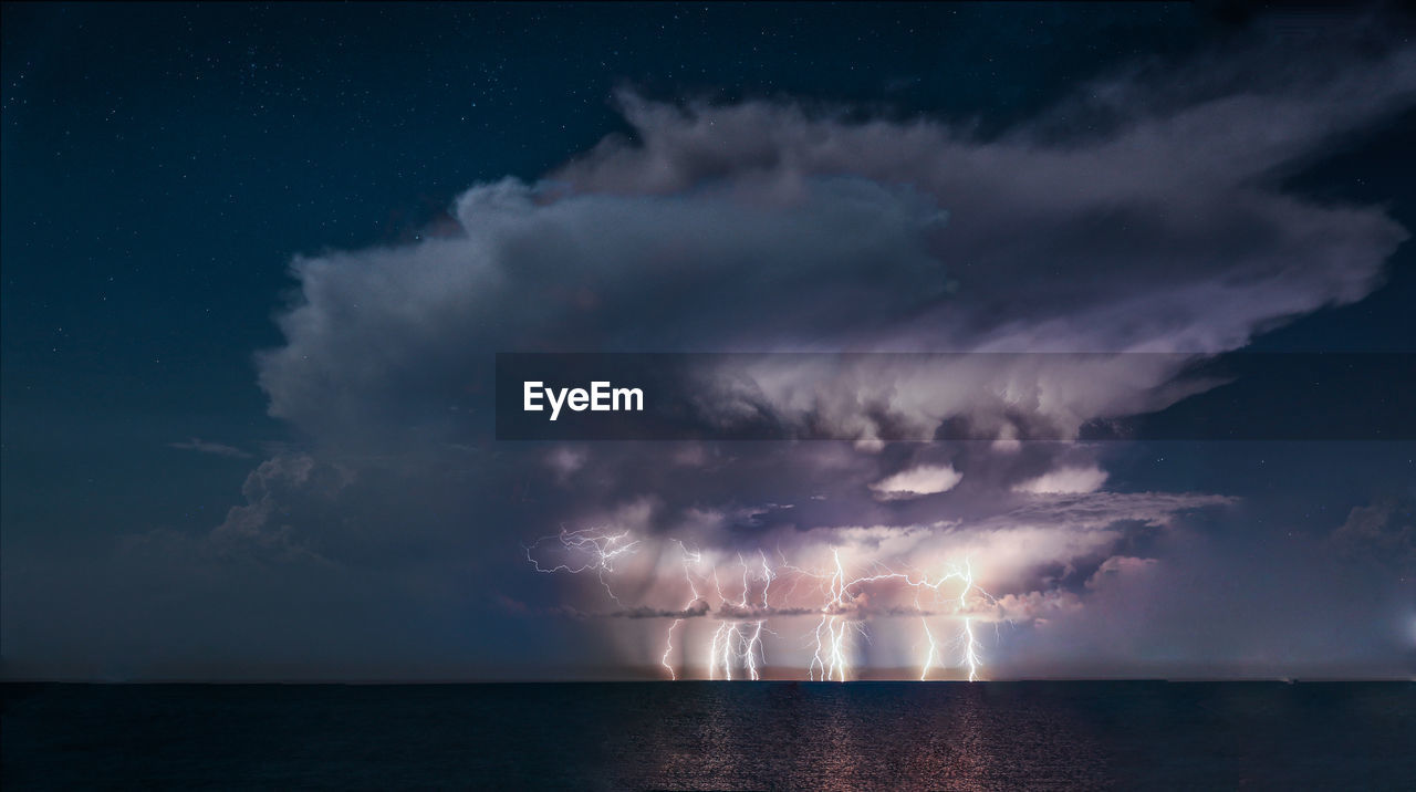 Scenic view of sea against sky at night