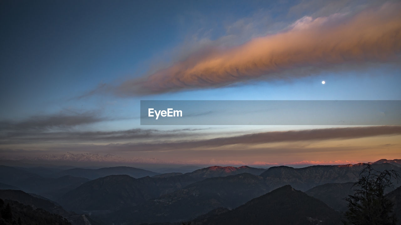 sky, mountain, scenics - nature, environment, beauty in nature, landscape, sunrise, cloud, dawn, mountain range, nature, tranquility, morning, tranquil scene, dramatic sky, no people, land, horizon, travel destinations, travel, outdoors, panoramic, sun, twilight, moon, mountain peak, winter, idyllic, fog, non-urban scene, cold temperature, tree, space, awe, tourism, snow, blue, sunlight, silhouette