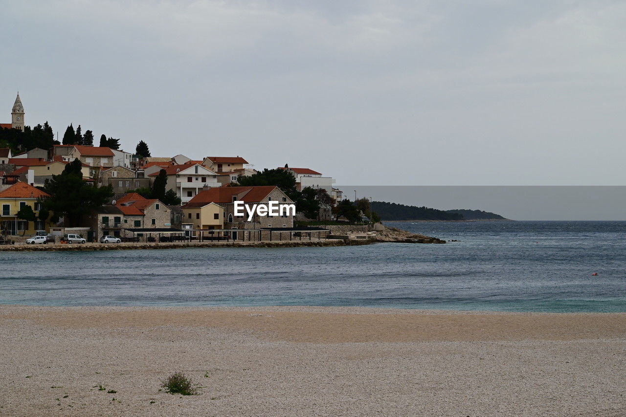 water, architecture, sea, land, beach, coast, sky, building exterior, built structure, building, shore, ocean, body of water, nature, travel destinations, vacation, house, travel, city, tourism, scenics - nature, cloud, coastline, beauty in nature, no people, sand, bay, trip, holiday, residential district, environment, landscape, outdoors, history, tranquility, day, the past, horizon, religion, water's edge, tranquil scene, idyllic, tower, horizon over water