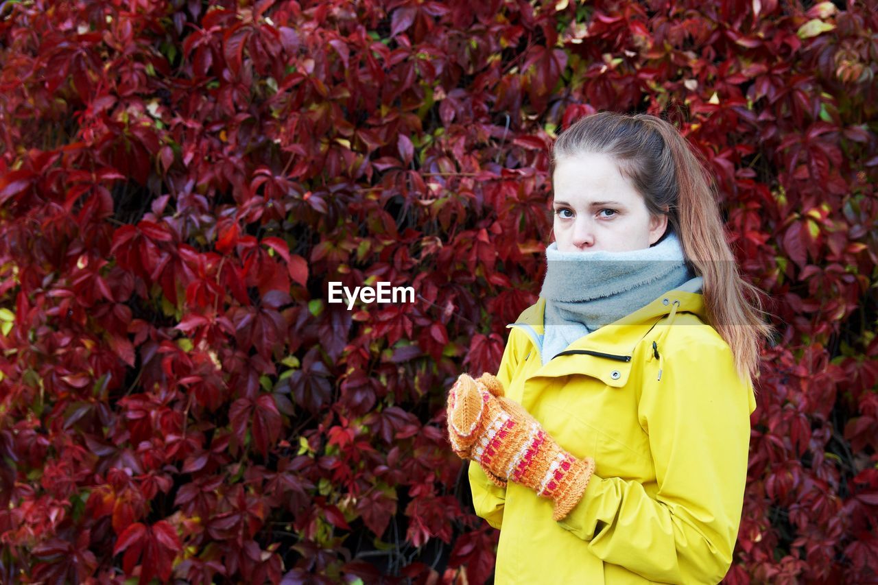 PORTRAIT OF A GIRL STANDING IN AUTUMN