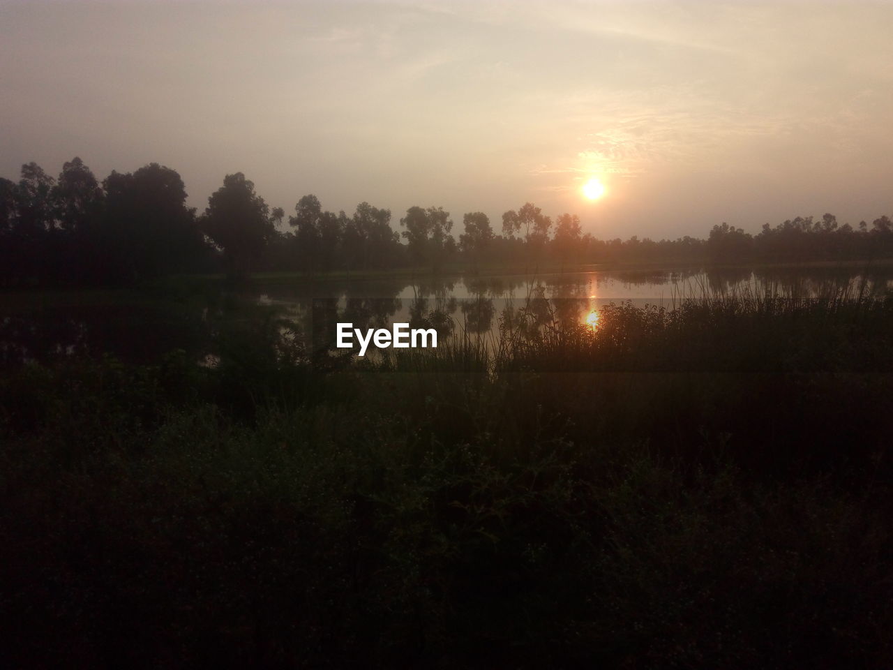 SCENIC VIEW OF LAKE DURING SUNSET