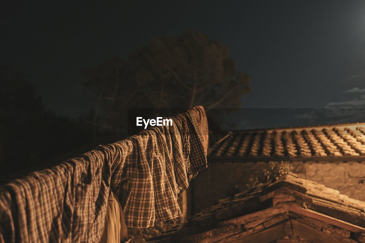 Low angle view of laundry for drying by house