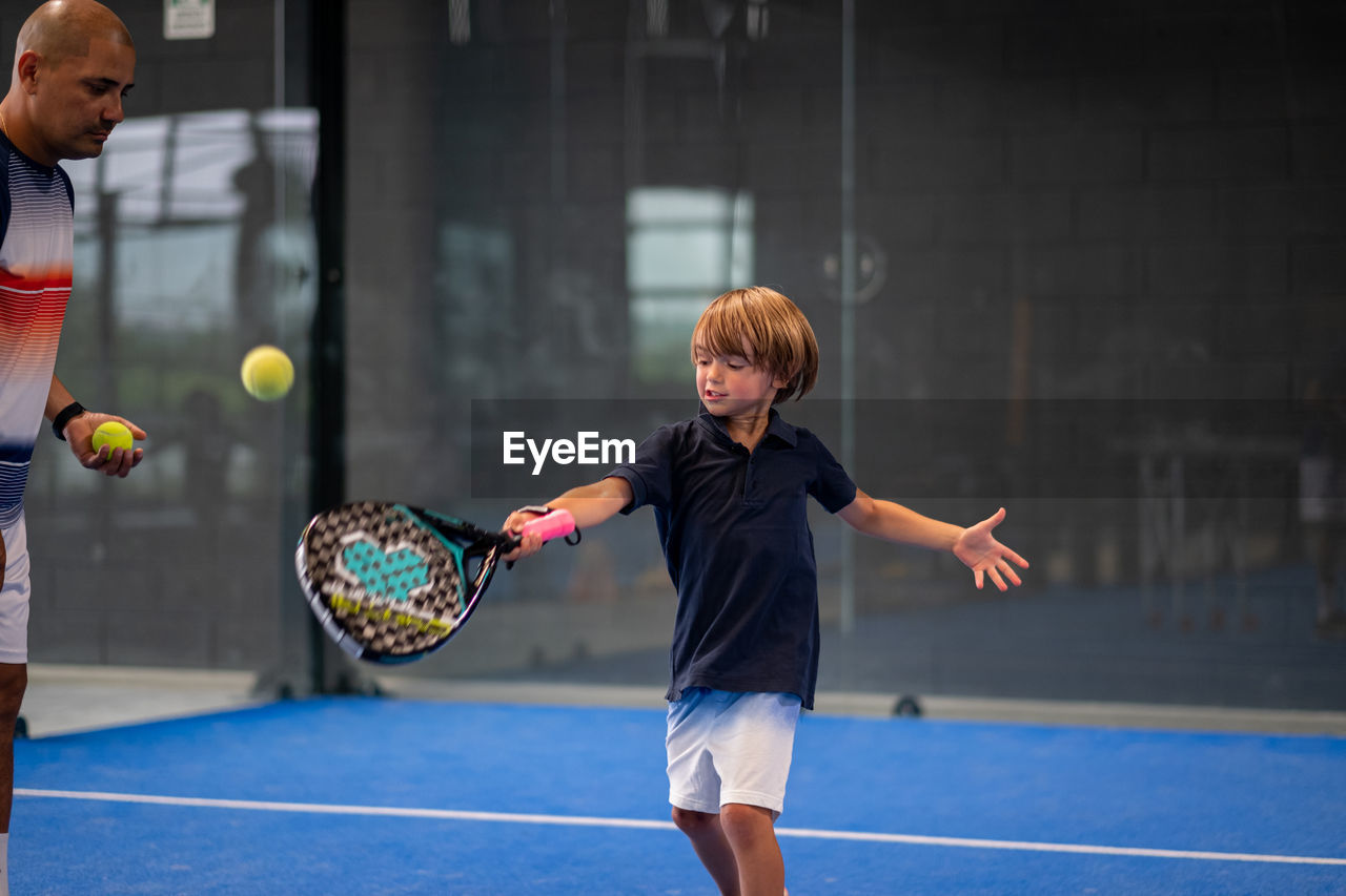 Full length of boy playing with ball