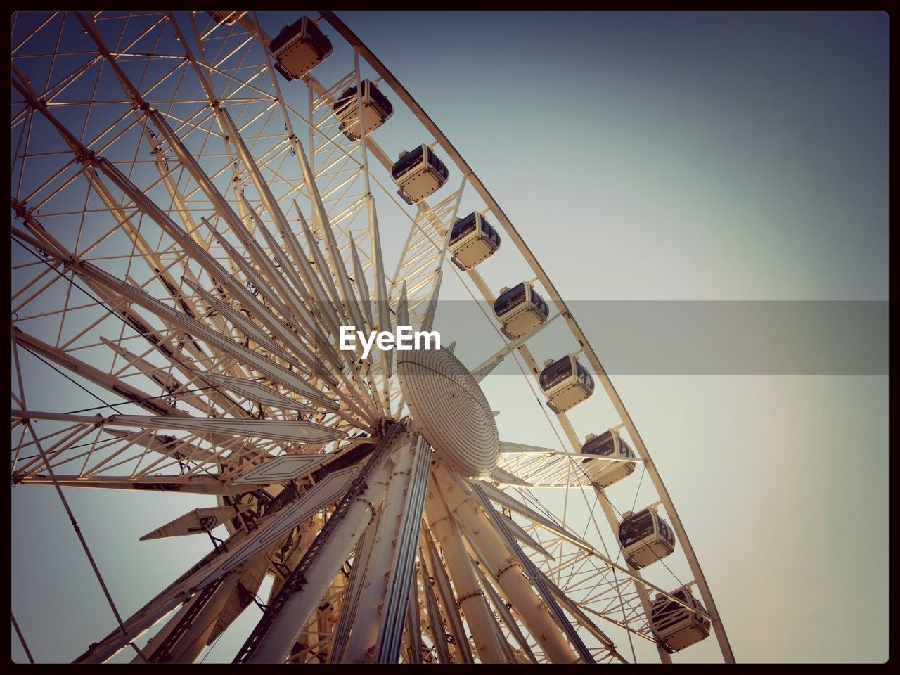 Low angle view of ferris wheel against clear sky