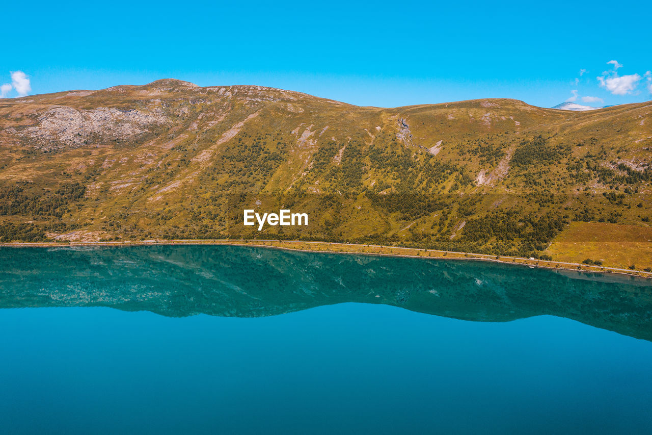 View of lake by mountain against sky