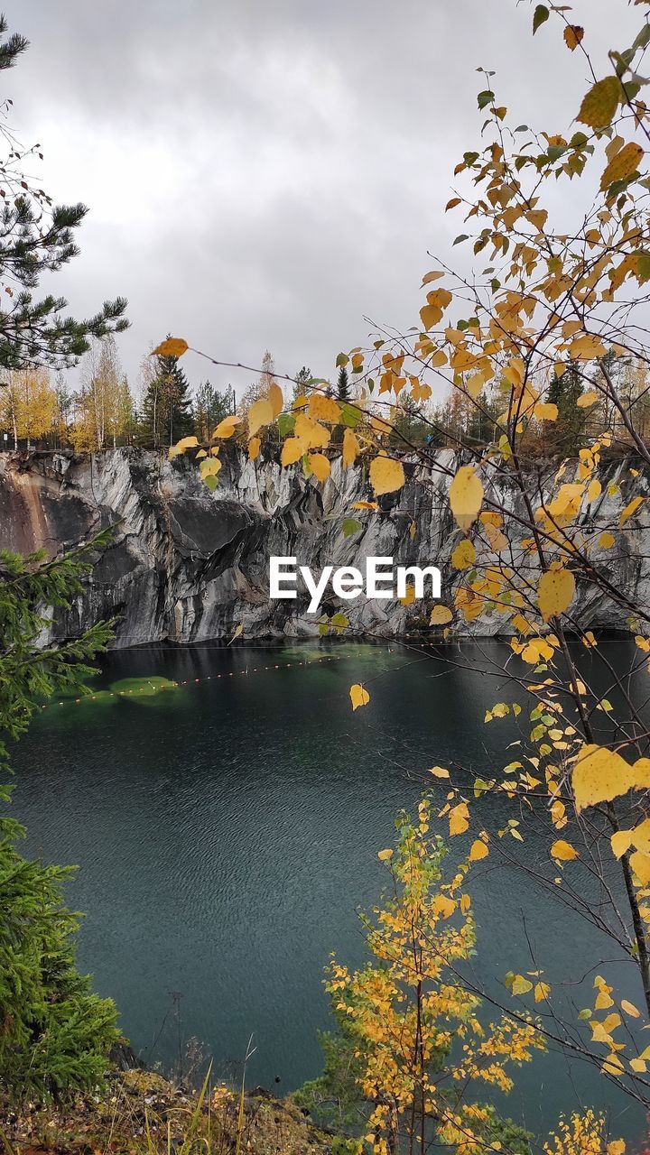 Scenic view of river against sky during autumn