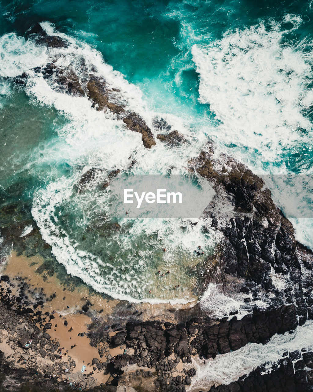 WAVES BREAKING ON ROCKS